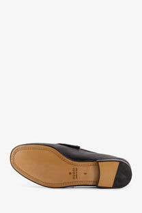 Black leather gucci men’s horsebit loafer with classic design and tan rubber sole for stylish comfort