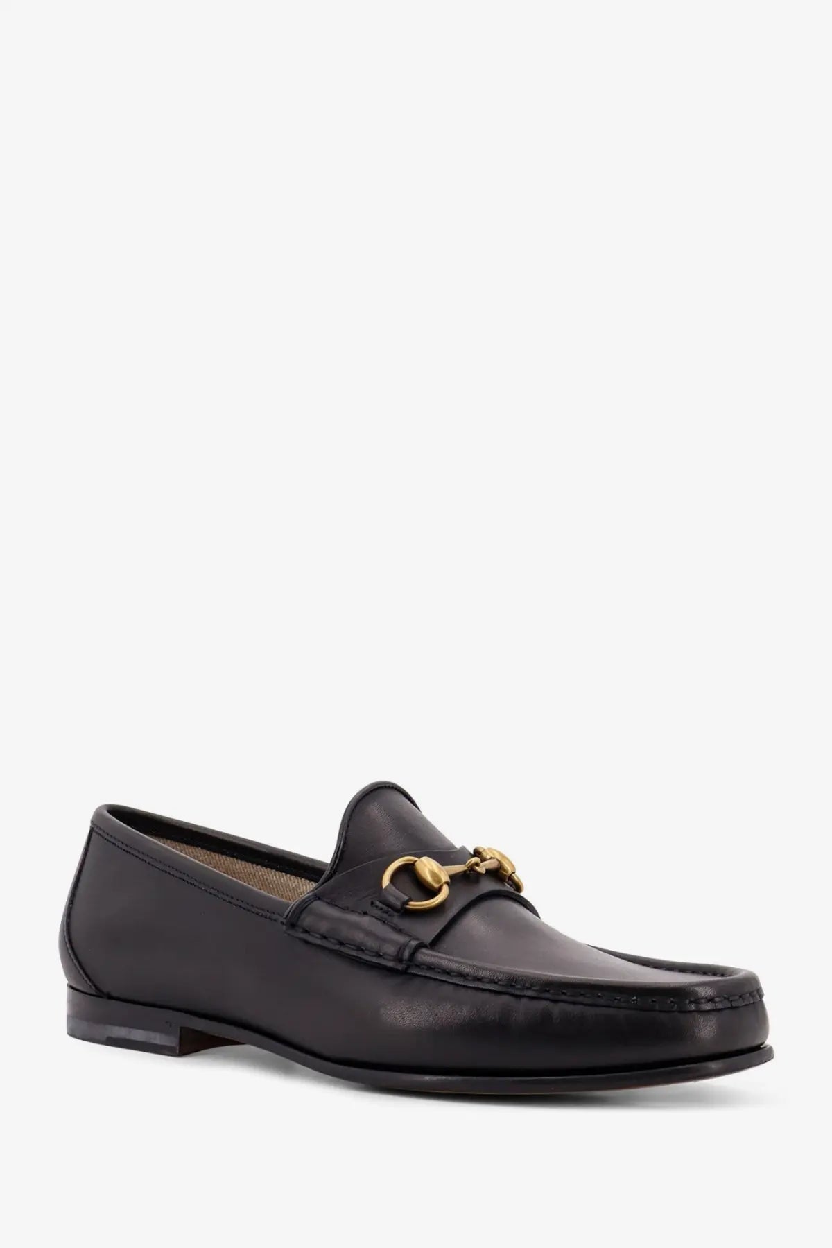 Gucci men’s horsebit leather loafer in black featuring a gold-tone horsebit buckle on the front