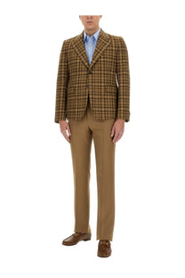 Gucci men’s beige brown and beige plaid double-breasted blazer worn over a light blue button-down shirt