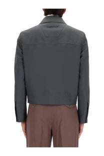 Gucci men’s dark gray structured jacket with clean lines and subtle stitching details