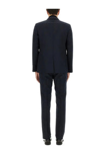 A sleek navy blue wool Gucci men’s jacquard dress suit with classic tailored fit and subtle texture