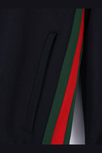 Black Gucci track pants with bold red and green striped side panel paired with Gucci men’s blue jersey sweatshirt