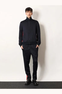Black zip-up track jacket with red side panels and jersey material designed for men by Gucci