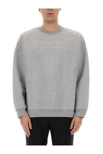 Gucci men’s grey jersey sweatshirt with gray heathered fabric and embossed logo across the chest
