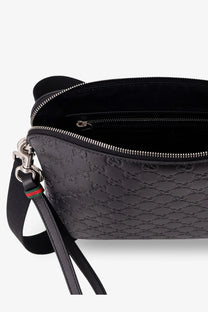 Black gucci men’s leather crossbody belt bag with embossed gg monogram pattern and silver-toned hardware