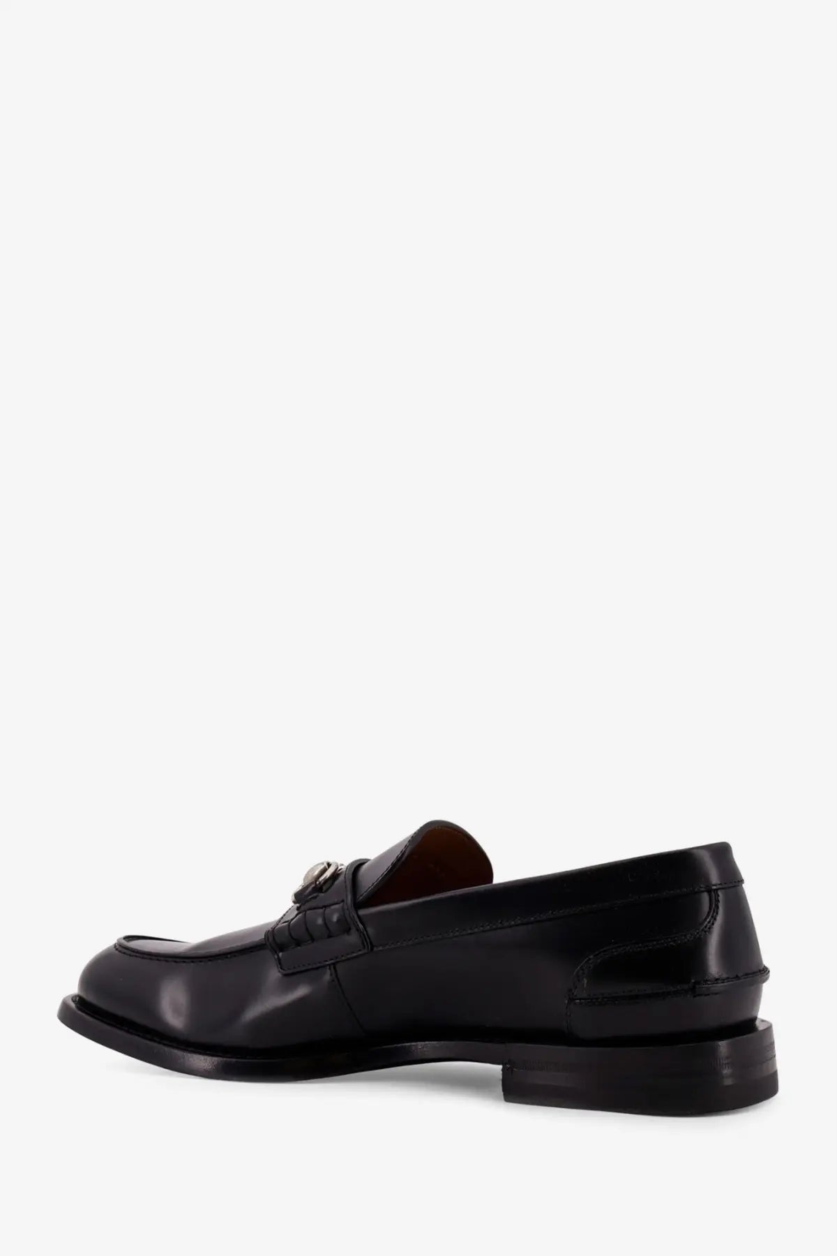 Gucci men’s black leather loafer with polished finish and decorative metal buckle on the vamp