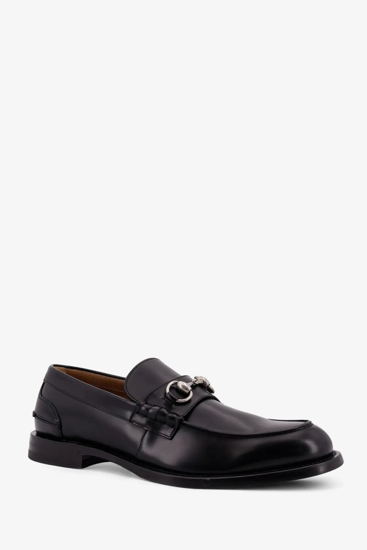 Gucci men’s black leather loafer with silver horsebit buckle showcasing classic luxury design