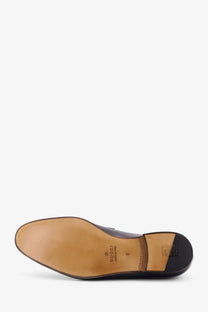 Black gucci leather dress shoe with tan rubber sole and stitched detailing from gucci men’s leather loafer blue collection