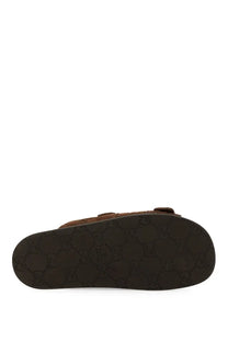 Gucci men’s brown leather slider sandal with black sole featuring signature interlocking GG pattern
