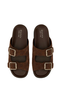 Gucci men’s brown suede leather slide sandals with double buckle straps and classic logo pattern