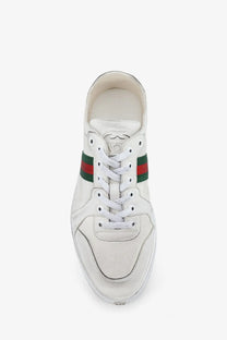 Gucci men’s white leather sneakers featuring classic red and green striped band across the side