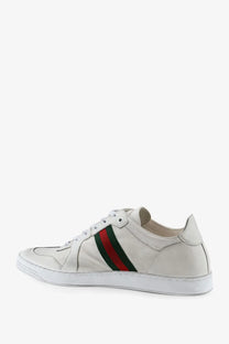 White leather Gucci men’s sneaker featuring classic red and green striped band across the side