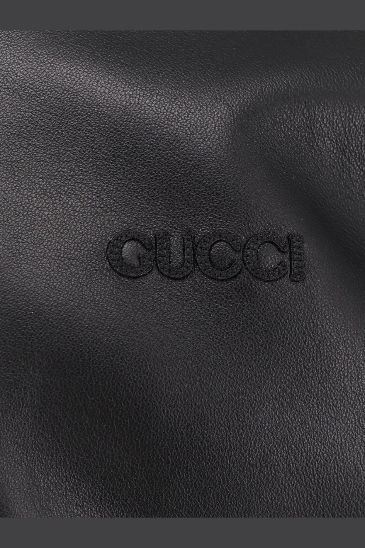 Black gucci leather bag with embossed logo complementing gucci men’s leather and wool jacket black