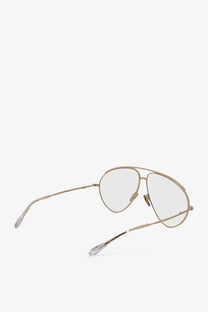 Gucci men’s beige metal sunglasses featuring gold-toned aviator frames with clear lenses and minimalist design