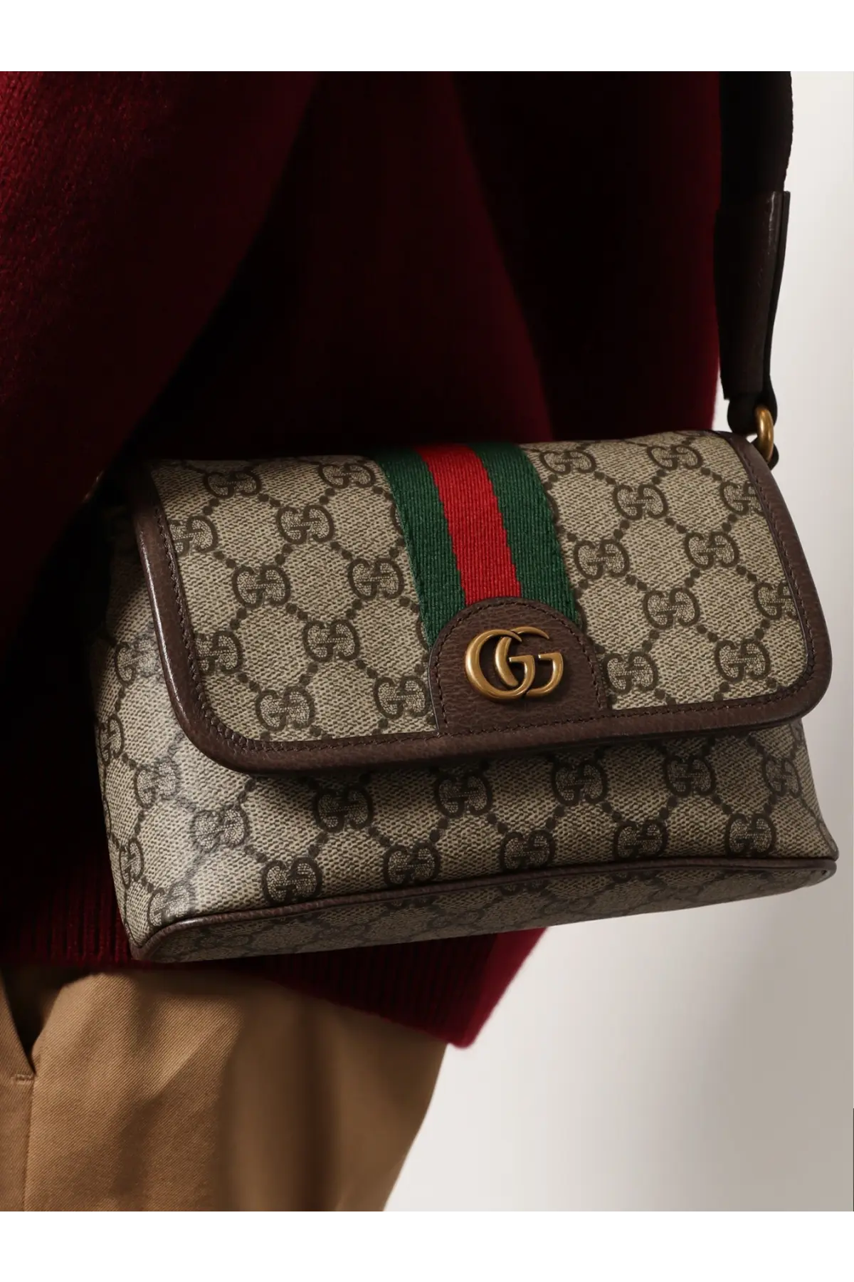 Beige and brown Gucci men’s mini Ophidia GG fabric crossbody bag with signature monogram canvas and gold hardware