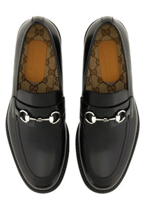 Black gucci men’s moccasin loafers in glossy leather with silver toned horsebit metal accents