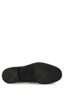 Black Gucci men’s moccasin loafers with classic double G logo embossed on the rubber sole