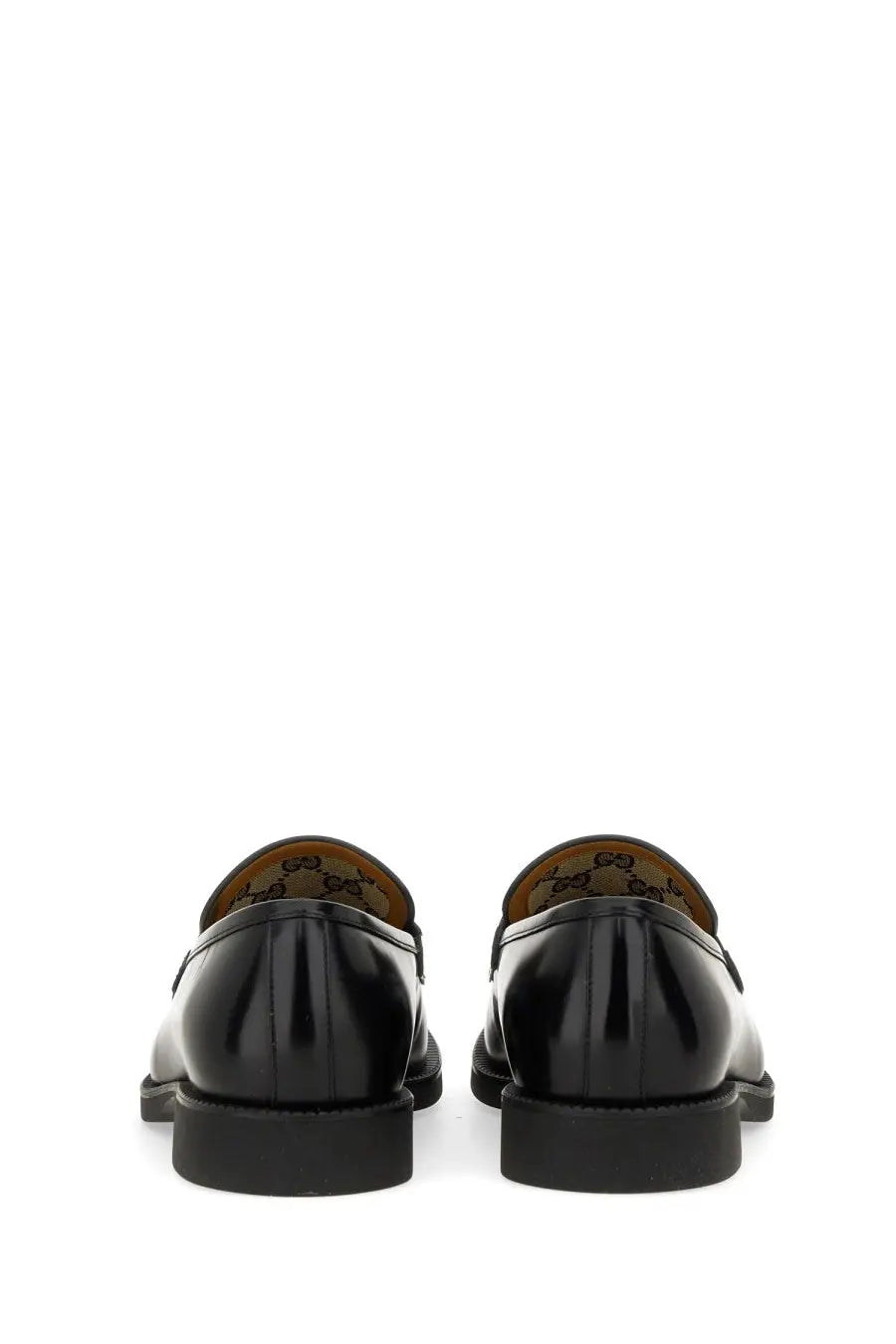Gucci men’s moccasin black patent leather loafers with a glossy finish and classic design