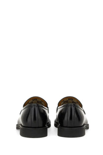 Gucci men’s moccasin black patent leather loafers with a glossy finish and classic design