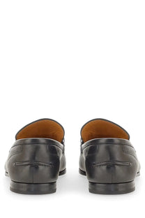 Gucci men’s moccasin Jordaan black leather loafers with smooth polished finish and contrasting tan lining