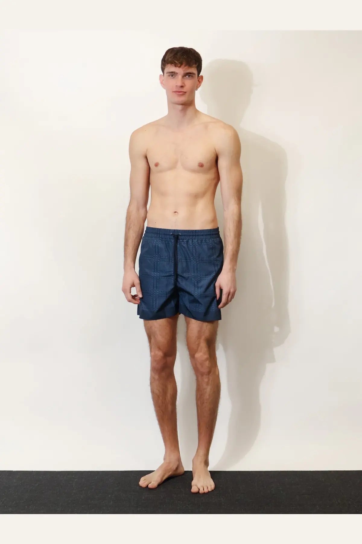 Navy blue textured nylon swim trunks with elastic waistband for men by Gucci ideal for swimming and beachwear