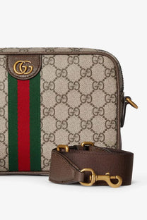 Beige and brown gucci men’s ophidia gg supreme fabric crossbody bag with red and green webbing and gold hardware