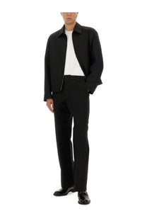Gucci men’s pants black paired with a black structured jacket with subtle sheen and minimalist design