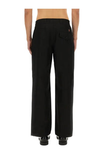 Gucci men’s black wide-leg trousers with a sleek tailored fit and subtle stitching details
