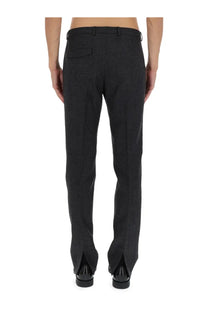 Gucci men’s wool trousers in black with textured fabric straight-leg cut and split cuffs front view