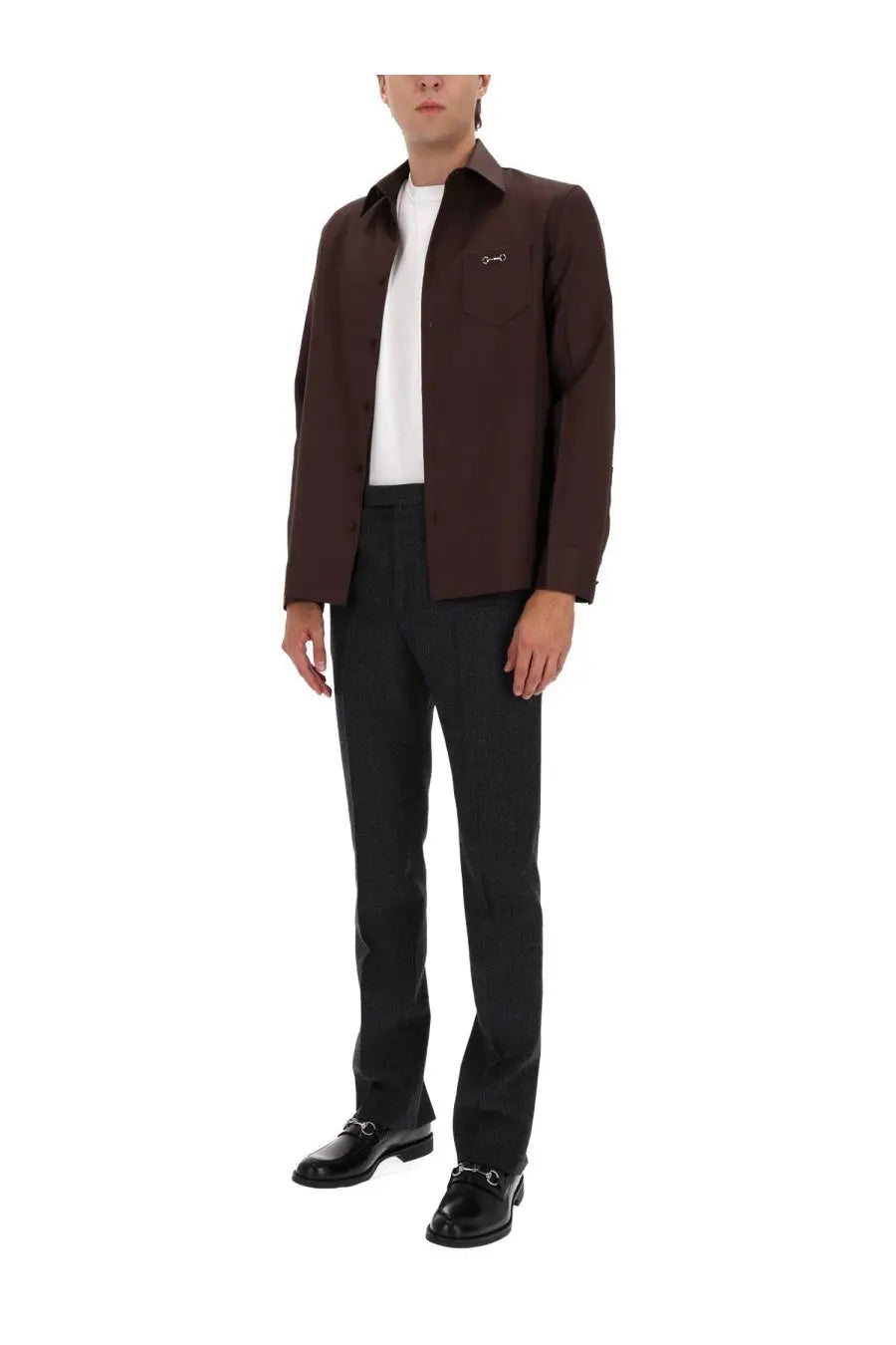 A dark brown gucci jacket with subtle embroidered logo paired with men’s mouliné grey pants