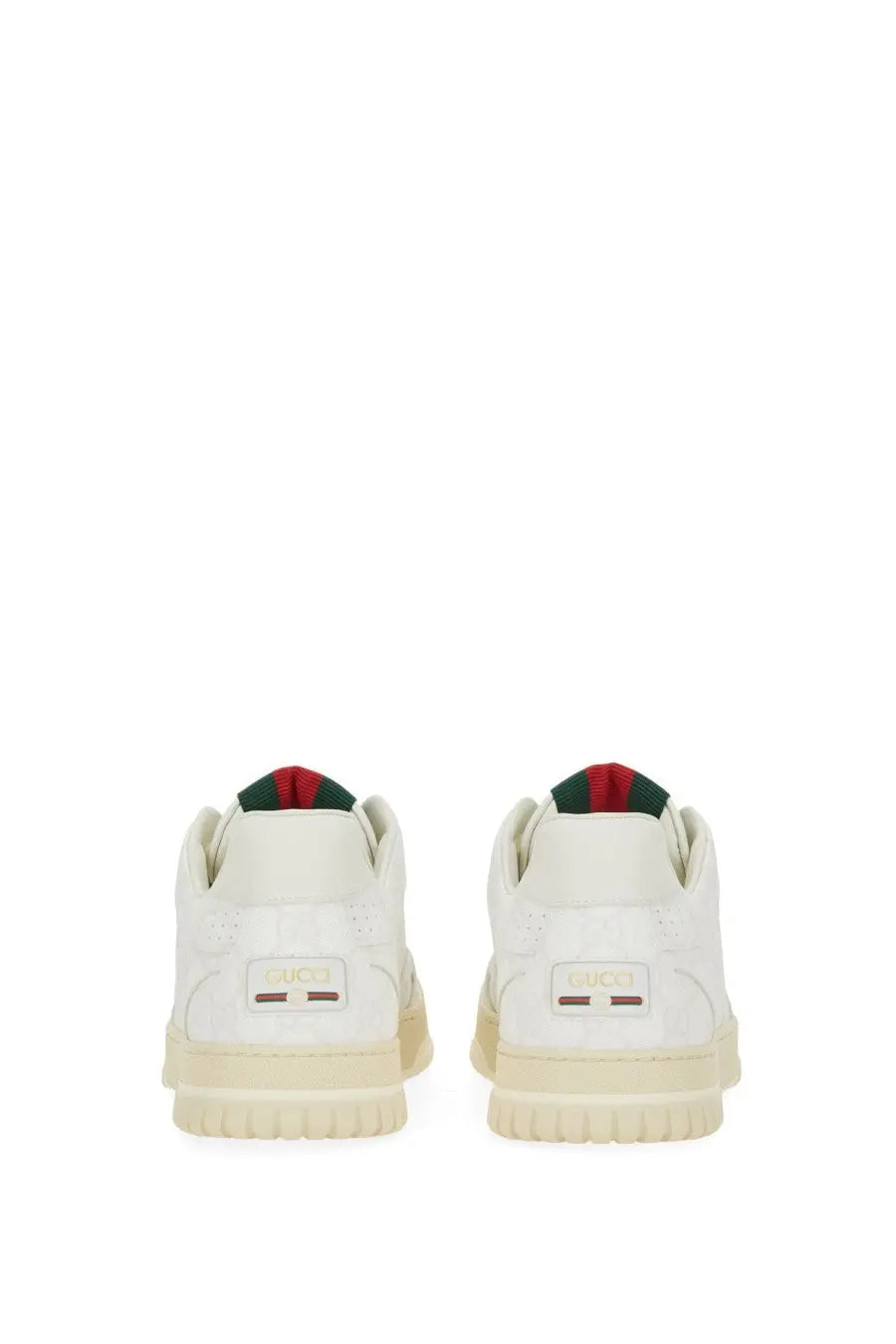 White gucci men’s re web sneaker with cream rubber sole and red and green striped fabric at the heel back side