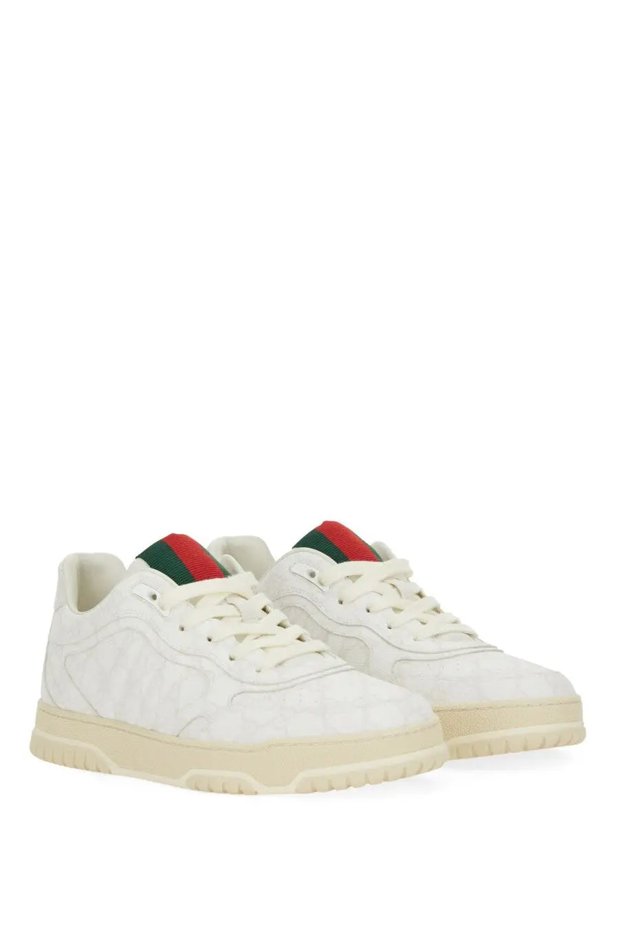 White gucci men’s re web sneaker with quilted texture cream soles and red and green striped tongue accents