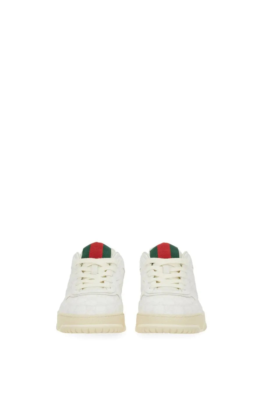 White gucci men’s re web sneaker with leather upper and red green striped accents on the tongue