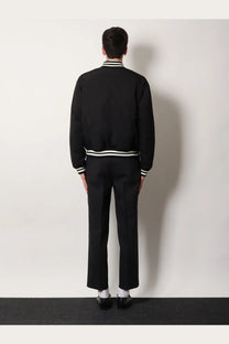 Gucci men’s reversible bomber jacket in black with white striped trim at collar cuffs and waistband