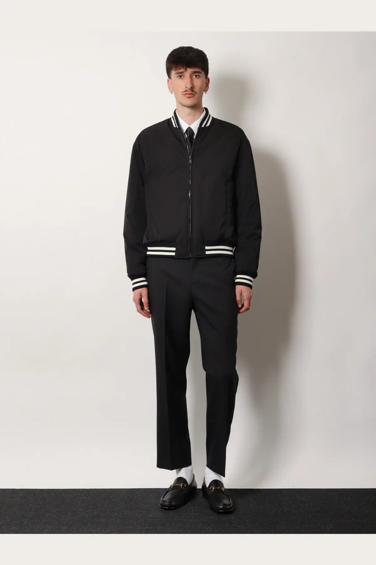 Gucci men’s reversible bomber black jacket with white striped cuffs and collar in a sleek design