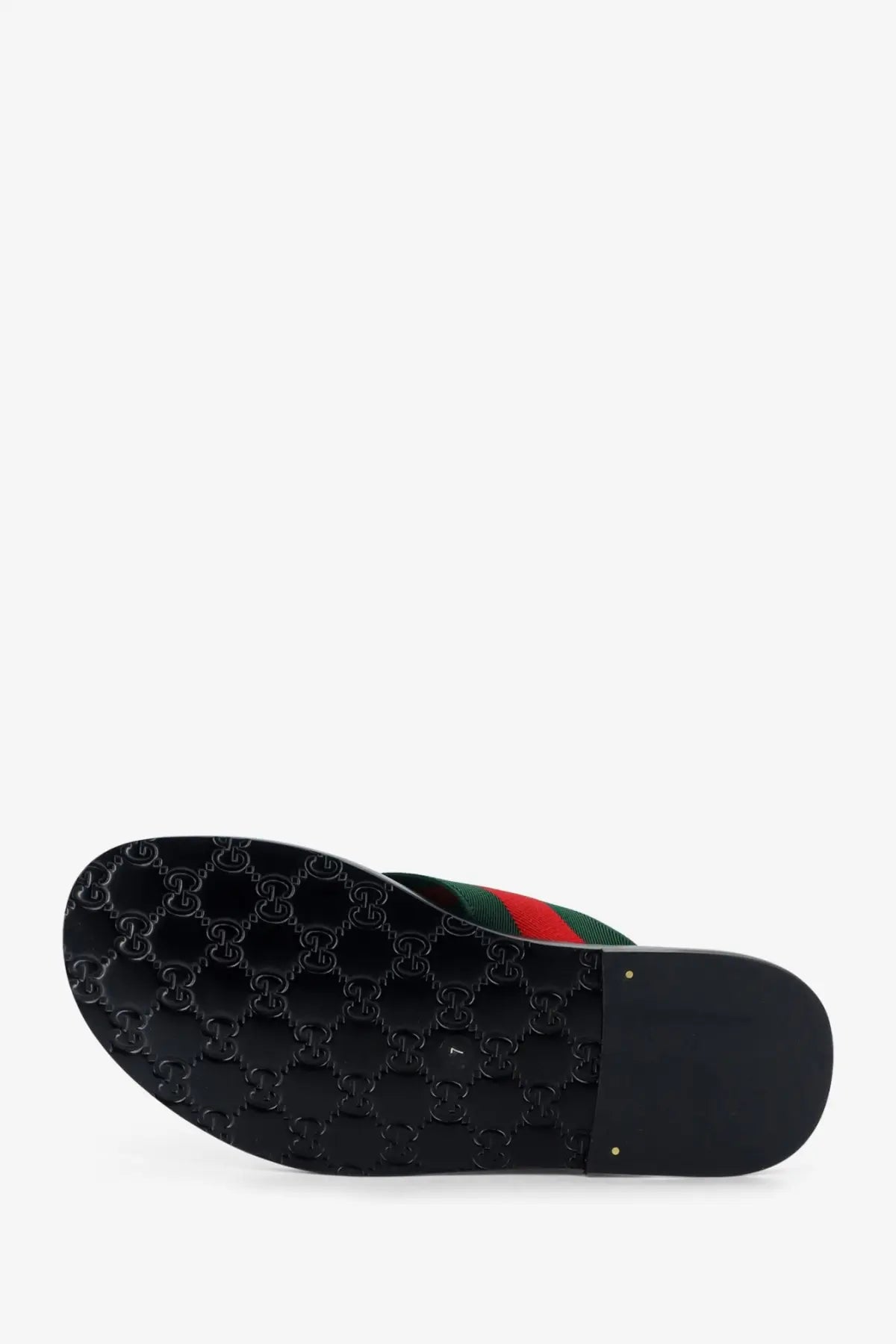 Black gucci men’s riviera leather slide sandal with glossy rubber sole embossed interlocking g logo and red green striped fabric upper