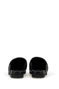 Gucci men’s sabot black leather slide sandals with chunky sole and subtle metallic detailing on the strap