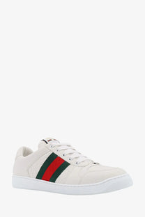 White gucci men’s screener leather sneaker with classic red and green striped webbing detail on the side