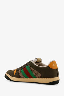Olive green gucci men’s screener low top sneaker with beige red green gg supreme panel orange heel tab and black sole