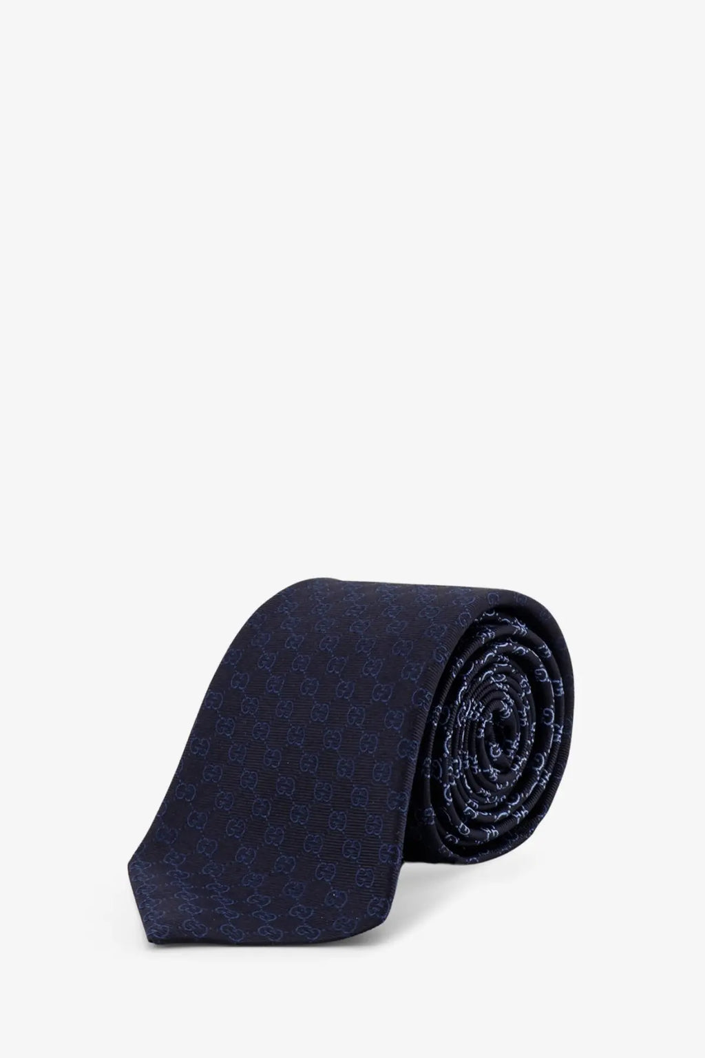 Gucci men’s shady silk tie in dark blue with a subtle repeating Gucci logo pattern
