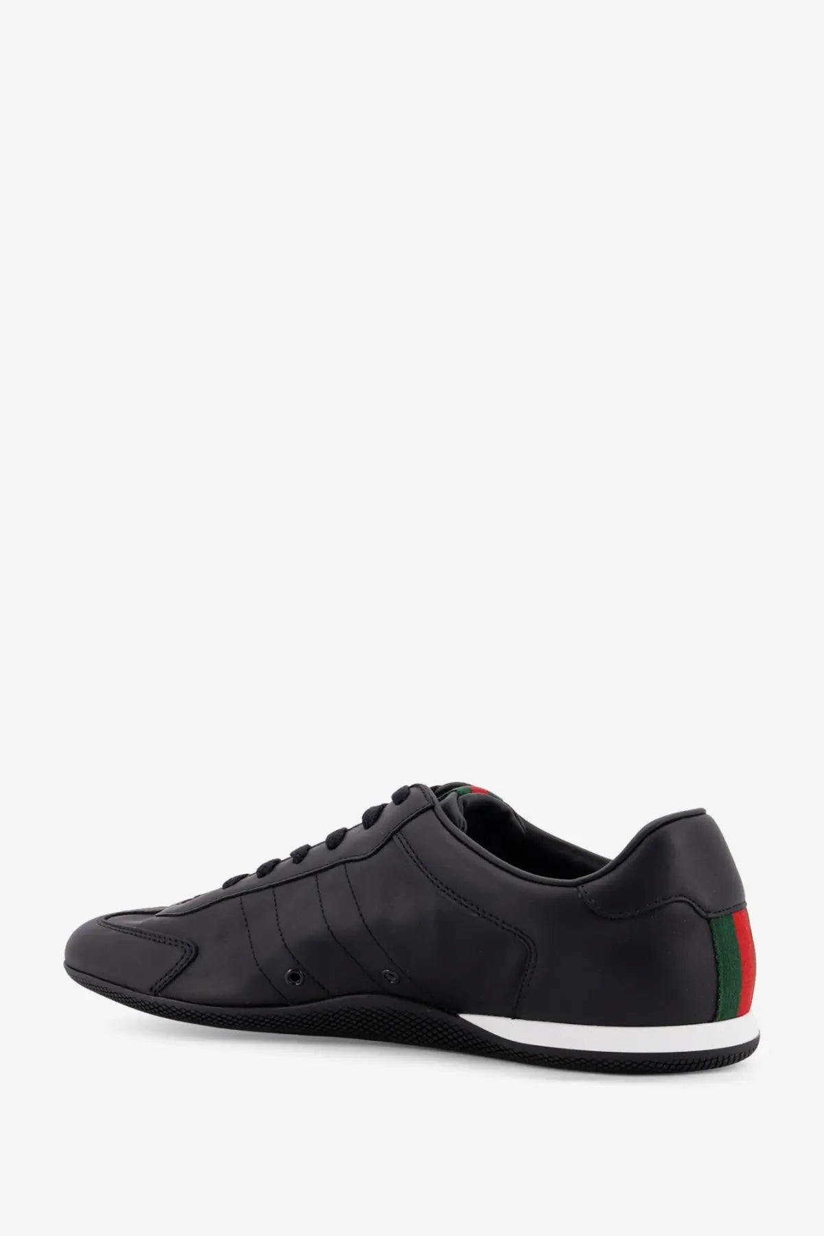 Black gucci mens shift leather sneakers showing back side with sleek leather upper and red green striped heel tab