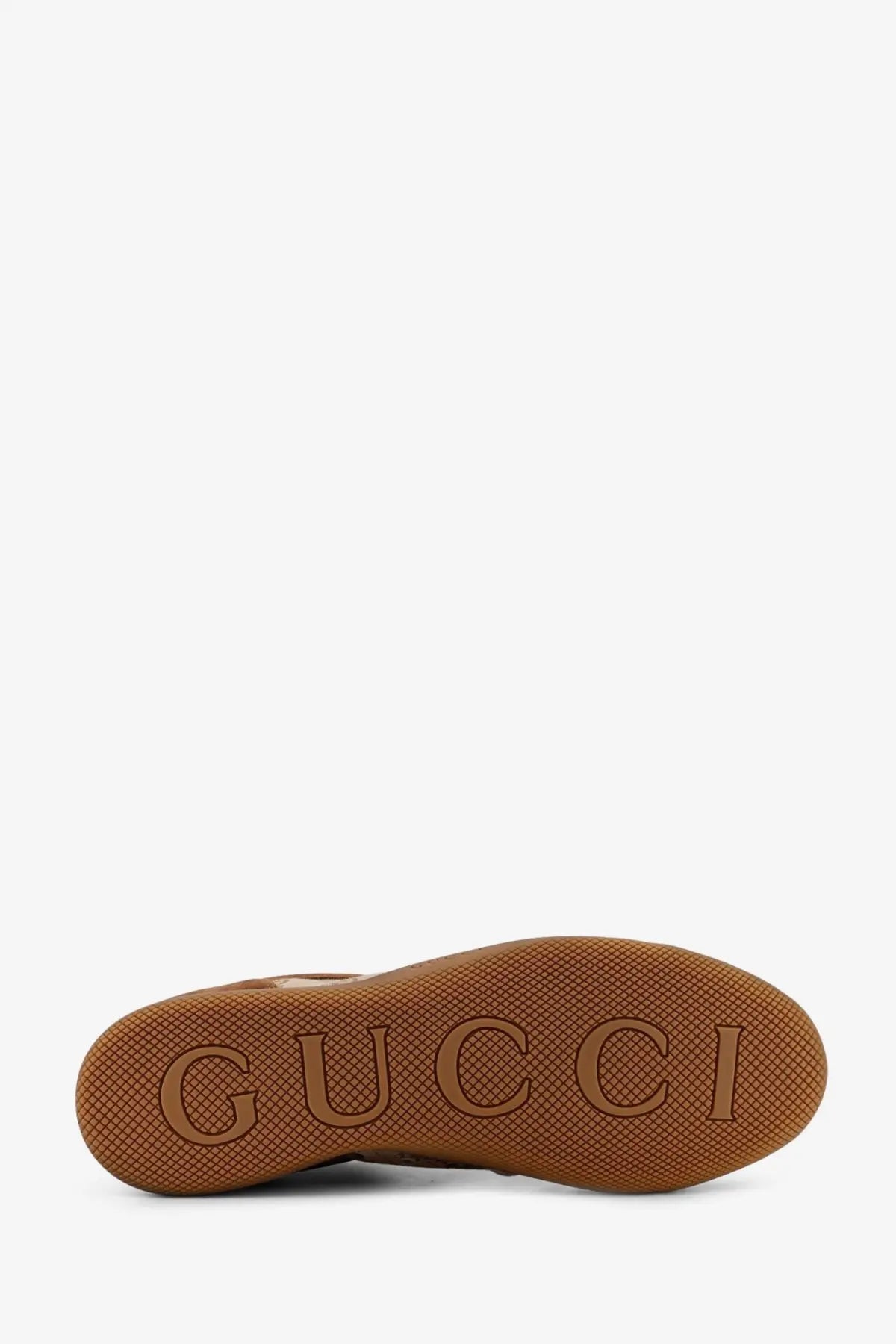 Brown rubber sole with embossed gucci logo on the back of gucci men’s yellow suede shift sneakers