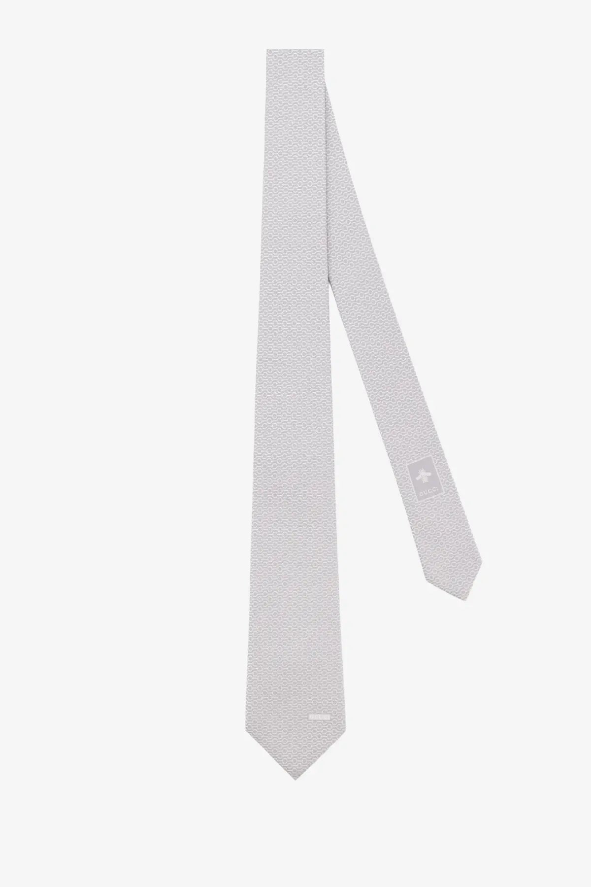 Gucci men’s silk tie in light gray with a subtle geometric pattern crafted from fine woven fabric