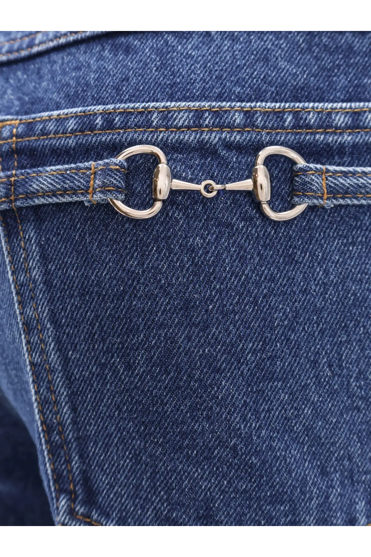 Silver horsebit buckle detail on blue denim gucci men’s slim five pocket jeans front side