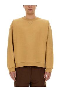 Gucci men’s mustard yellow oversized crewneck sweatshirt with subtle triangular seam detail at the neckline