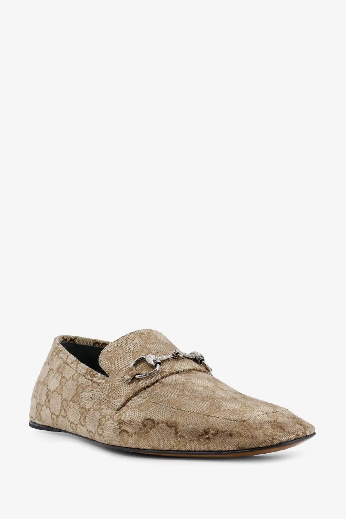 Beige Gucci men’s vintage effect GG fabric loafers with repeating monogram pattern and silver horsebit detailing