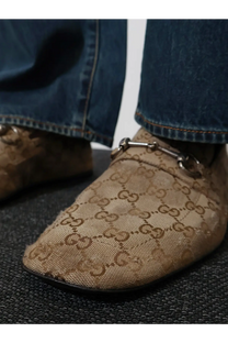 Beige Gucci men’s vintage effect loofers in GG fabric with repeating monogram and metallic horsebit detailing