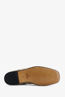 Tan leather sole of gucci men’s vintage effect gg fabric loafers beige with black rubber heel and logo printed in black