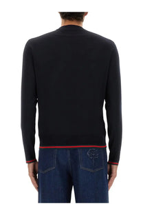 Back view of a black gucci sweater with red trim and rose embroidery on the back pocket from the gucci men’s web pattern sweater blue collection