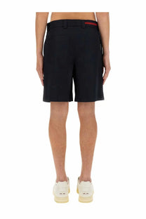 Gucci men’s blue tailored shorts with red stripe accent on waistband designed for stylish casual wear